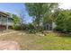 Large backyard with lush landscaping, mature trees and a storage shed at 7046 W 62Nd Pl, Arvada, CO 80003