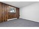 A finished basement with neutral carpet and wood paneling at 7046 W 62Nd Pl, Arvada, CO 80003