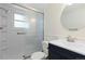 Cozy bathroom featuring a glass-enclosed shower and sleek vanity with modern sink at 7046 W 62Nd Pl, Arvada, CO 80003
