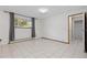 Neutral bedroom with tile floors and ample light from the large window at 7046 W 62Nd Pl, Arvada, CO 80003