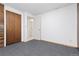 A simple bedroom with a carpeted floor, a double closet, and white walls at 7046 W 62Nd Pl, Arvada, CO 80003