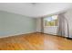 Neutral primary bedroom with hardwood floors, a large window, and ample natural light, offering a serene retreat at 7046 W 62Nd Pl, Arvada, CO 80003