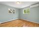 Bedroom with hardwood floors, windows and light-blue walls at 7046 W 62Nd Pl, Arvada, CO 80003