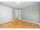 A bedroom with hardwood floors, closet and light-blue walls at 7046 W 62Nd Pl, Arvada, CO 80003