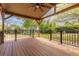 Beautiful, covered deck with ceiling fan and black metal railing overlooking green backyard at 7046 W 62Nd Pl, Arvada, CO 80003