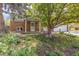 Two-story home with beautiful yard, mature trees, and a partial brick facade, complete with a two-car garage at 7046 W 62Nd Pl, Arvada, CO 80003
