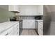 Modern kitchen with white cabinets, stainless steel appliances, and updated countertops, creating a bright and functional space at 7046 W 62Nd Pl, Arvada, CO 80003