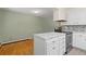 Bright kitchen features white cabinetry, an island with marble countertop and stainless steel appliances at 7046 W 62Nd Pl, Arvada, CO 80003