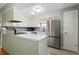 Modern kitchen with white cabinets, stainless steel appliances, and stylish backsplash, offering a functional and elegant space at 7046 W 62Nd Pl, Arvada, CO 80003