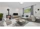 Inviting living room with a fireplace, large windows, and neutral decor at 7046 W 62Nd Pl, Arvada, CO 80003