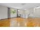 Bright living space featuring hardwood floors, a large window, and stylish built-in shelving for storage and display at 7046 W 62Nd Pl, Arvada, CO 80003
