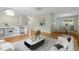 Bright and open living room featuring hardwood floors, modern decor, and seamless access to the dining area at 7046 W 62Nd Pl, Arvada, CO 80003