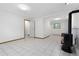 Open living space with a tile floor, a wood burning stove, and white walls at 7046 W 62Nd Pl, Arvada, CO 80003