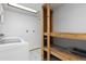 Functional storage space with built-in shelving, tile flooring and white walls at 7046 W 62Nd Pl, Arvada, CO 80003