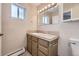 Classic bathroom featuring a single sink vanity, a large mirror and neutral decor at 8100 W Quincy Ave # D, Denver, CO 80123