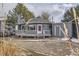 Charming home featuring a round design, deck, red door, gray color scheme, and landscaped front yard at 8100 W Quincy Ave # D, Littleton, CO 80123