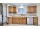 Charming kitchen with wooden cabinets, granite countertops and stainless steel dishwasher at 8100 W Quincy Ave # D, Littleton, CO 80123