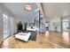 Bright and airy living room featuring a stone fireplace, spiral staircase, and hardwood floors at 8100 W Quincy Ave # D, Denver, CO 80123