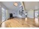 Bright and airy living room with a stone fireplace, spiral staircase, and hardwood floors at 8100 W Quincy Ave # D, Denver, CO 80123