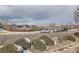 Scenic street view showcasing neighborhood homes, landscaping, and mountain views on a cloudy day at 8100 W Quincy Ave # D, Littleton, CO 80123