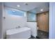 Luxurious bathroom with a freestanding tub, a glass-enclosed shower, and elegant black marble flooring at 1819 N Grove St, Denver, CO 80204