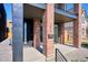 Modern entrance with red brick accents, black trim and fixtures and concrete steps at 1819 N Grove St, Denver, CO 80204