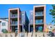 Modern townhomes featuring brick and metal accents, and multiple balconies at 1819 N Grove St, Denver, CO 80204