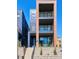 Modern townhome with brick and metal accents, three balconies and landscaped entrance at 1819 N Grove St, Denver, CO 80204