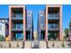 Modern townhomes featuring brick and metal accents, and multiple balconies at 1819 N Grove St, Denver, CO 80204