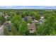 An aerial view showcases a house with mature trees in a suburban neighborhood at 7582 S Newport Ct, Centennial, CO 80112