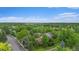 An aerial view of a home nestled among mature trees in a serene, suburban neighborhood at 7582 S Newport Ct, Centennial, CO 80112