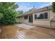Backyard features wood deck, concrete patio, lush greenery, and ample entertaining space at 7582 S Newport Ct, Centennial, CO 80112
