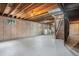 Unfinished basement with washer and dryer hookups and exposed ceiling beams at 7582 S Newport Ct, Centennial, CO 80112