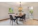 Cozy dining room featuring a stylish table and chairs, complemented by natural light from a window at 7582 S Newport Ct, Centennial, CO 80112