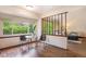 Bright dining area with a modern table set and a view of the living room through wooden slats at 7582 S Newport Ct, Centennial, CO 80112