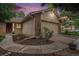 Charming home exterior features a two-car garage with stone accents and landscaped yard at 7582 S Newport Ct, Centennial, CO 80112