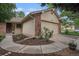 Charming home exterior features a two-car garage with stone accents and landscaped yard at 7582 S Newport Ct, Centennial, CO 80112
