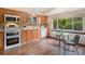 Bright kitchen with wooden cabinets, modern appliances, backsplash, and hardwood floors at 7582 S Newport Ct, Centennial, CO 80112