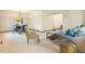 Open-concept living room with a view of the dining area, featuring cozy furniture and natural light at 7582 S Newport Ct, Centennial, CO 80112