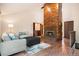 Spacious living room with vaulted ceilings, a wood-paneled fireplace, and modern furnishings at 7582 S Newport Ct, Centennial, CO 80112