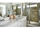 Bathroom featuring double sinks, quartz countertops, and a glass-enclosed shower at 39733 Penn Rd, Elizabeth, CO 80107