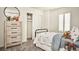 bedroom with a cute dresser, open closet space, shuttered window, and decorative wall mirror at 39733 Penn Rd, Elizabeth, CO 80107
