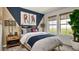 Cozy bedroom with sports themed wall art, plenty of natural light, and comfortable furnishings at 39733 Penn Rd, Elizabeth, CO 80107