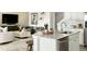 Bright kitchen with island, stainless appliances, and open floor plan flows into the living area at 39733 Penn Rd, Elizabeth, CO 80107
