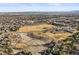 Wide aerial view showcasing the vast community with a school in the midground at 10588 E Park Mtn, Littleton, CO 80127