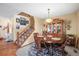 Traditional dining room with a wooden table, china cabinet, and staircase at 10588 E Park Mtn, Littleton, CO 80127