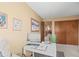 Bright home office with white desk, neutral walls, and natural light near hall closet at 10588 E Park Mtn, Littleton, CO 80127