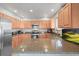 Modern kitchen with stainless steel appliances, granite countertops, and ample cabinet space at 10588 E Park Mtn, Littleton, CO 80127