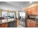 Open-concept kitchen and breakfast nook, featuring stainless steel appliances and granite countertops at 10588 E Park Mtn, Littleton, CO 80127