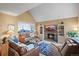 Cozy living room with a brick fireplace, comfortable seating, and vaulted ceilings at 10588 E Park Mtn, Littleton, CO 80127